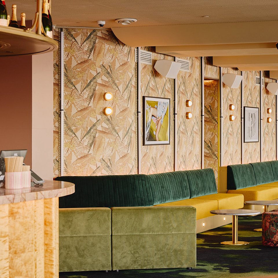 Commercial lounge with patterned wallcovering and upholstered seating