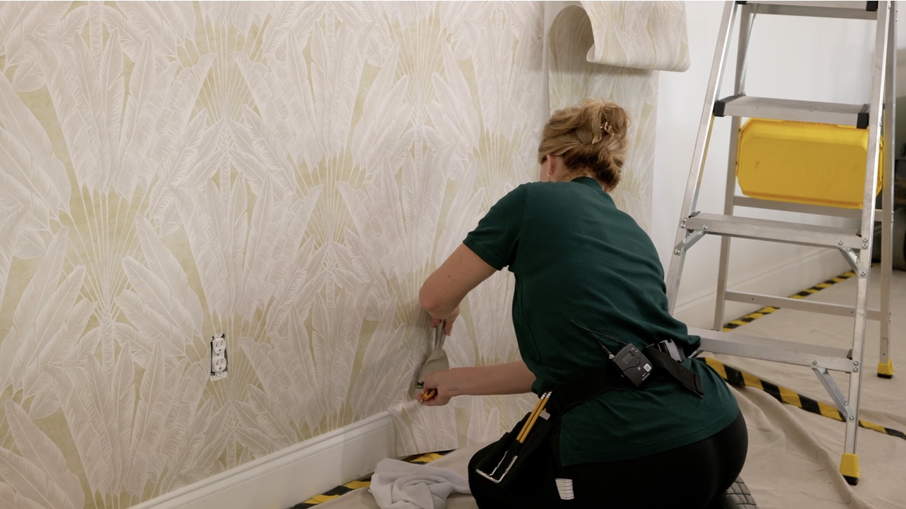 Installer working on a textured wallpapered wall