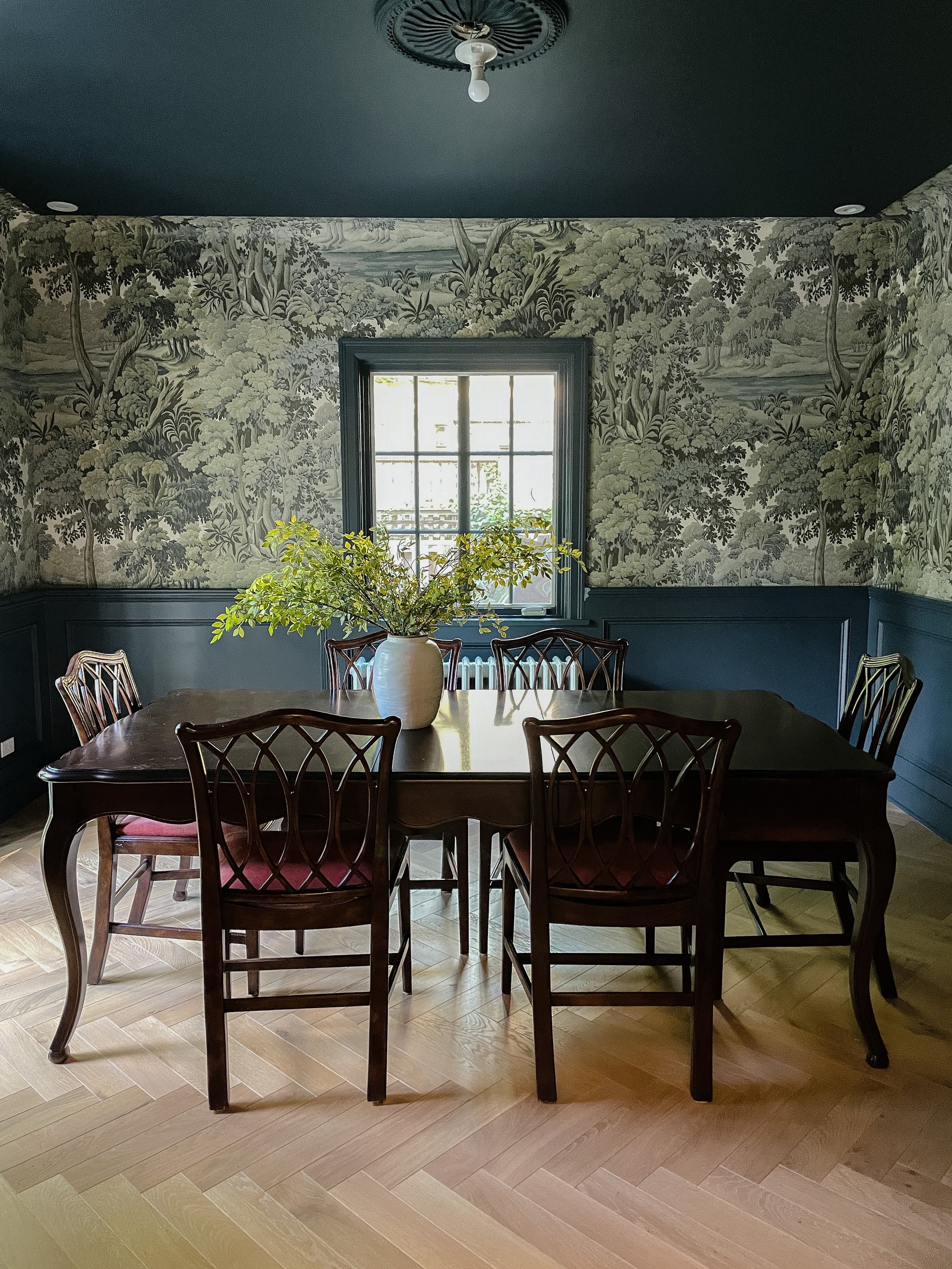 Elegant dining room featuring scenic floral wallcovering